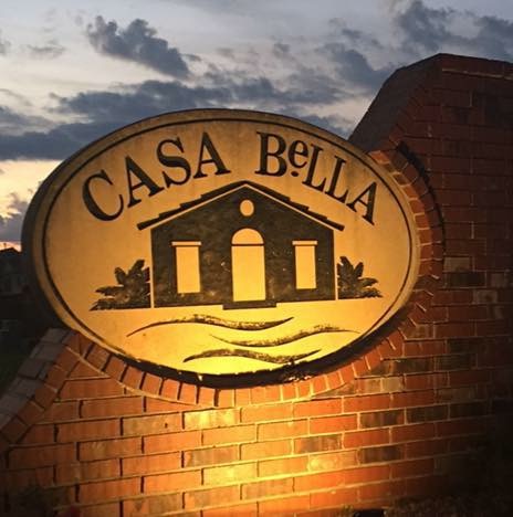 Casa Bella brick entrance monument at sunset
